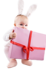 Baby in bunny costume with present