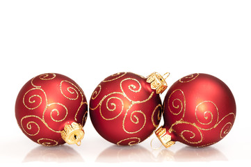 three red christmas balls isolated on white background