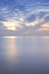 Fototapeta na wymiar Beautiful fiery glow sunset reflected in smooth sea
