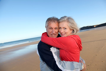 Fototapeta na wymiar Senior couple exercising by the sea