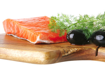 pink smoked salmon on wooden plate with white cheese