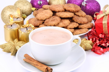 Cup of hot cocoa, cinnamon cookies and christmas decoration