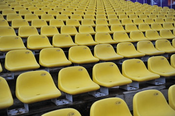 Fototapeta premium yellow plastic chair in the stadium