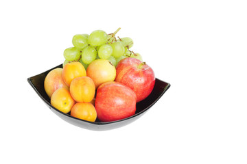 Fresh fruits in a bowl isloated on white