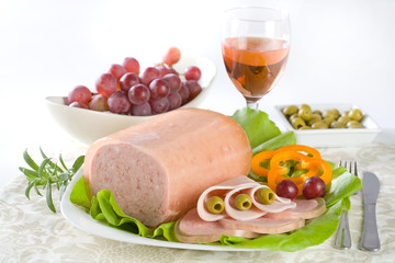 Luncheon meat, salad, olives and grapes