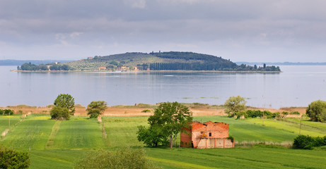 Landscape of old farmhouse, lake and island