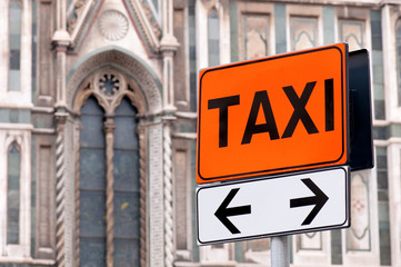 Taxi rank sign with Italian church in background