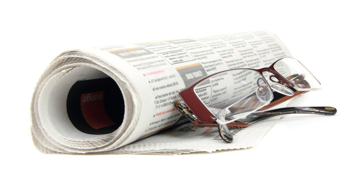 Roll of newspapers with eyeglasses