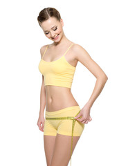 Obraz premium Woman with perfect body measuring buttocks