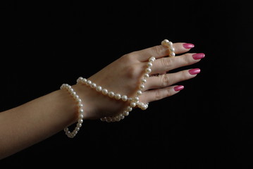 Woman hand with pearl beads
