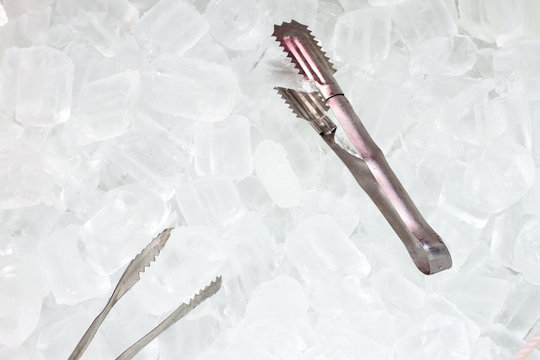 ice   with tongs closeup .