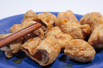 Fried fish balls with chopsticks.