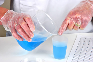 im Labor blaue Flüssigkeit umfüllen
