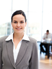 Young businesswoman standing in front of her team