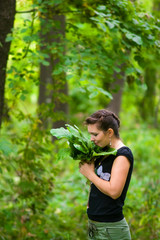 woman in the woods keeps leaves