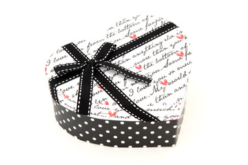 perspective of isolated black and white holiday gift box in hear