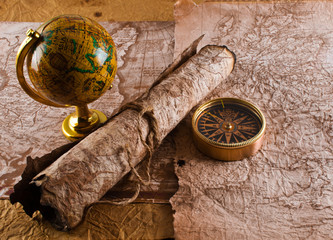 Old compass and globe on grunge background
