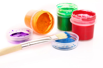 Colorful vibrant cans of gouache and brush isolated on white