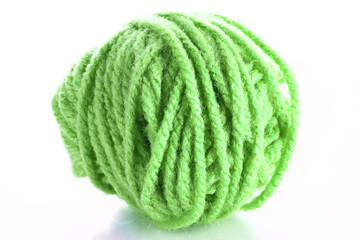 Green ball of woollen red thread isolated on white