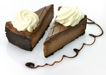 A triple chocolate cheesecake with whipped cream.