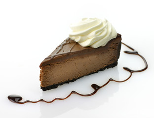 A triple chocolate cheesecake with whipped cream.