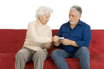 elderly couple on the couch with money in hand