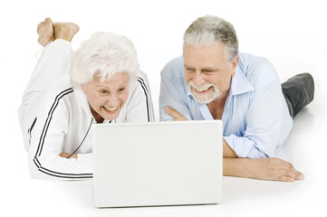 elderly couple using laptop