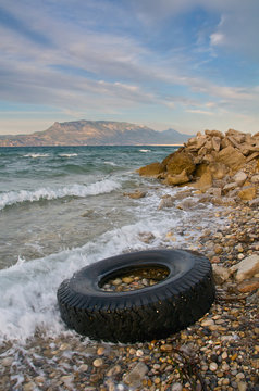 Lorry tyre on sea shore - Pollution