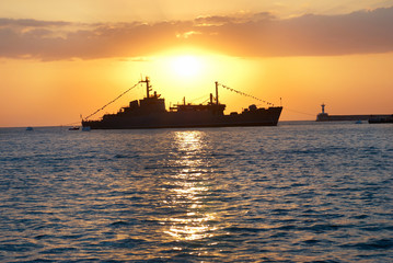 Fototapeta premium Military ship against sunset