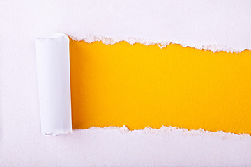 ripped paper displaying a yellow background