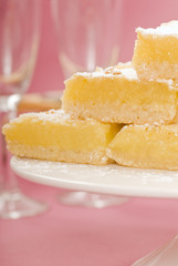 Lemon squares on a white cake stand