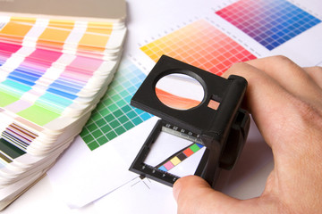 Holding a lupe and examing colours