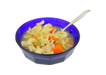 Chicken soup and spoon in blue bowl