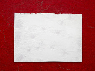 White paper stick on crack old red wall