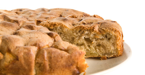 cinnamon apple pie with one piece cut out, on a plate;