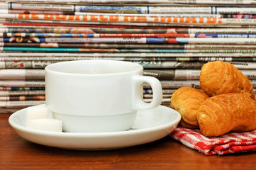 Cup from coffee and the newspaper