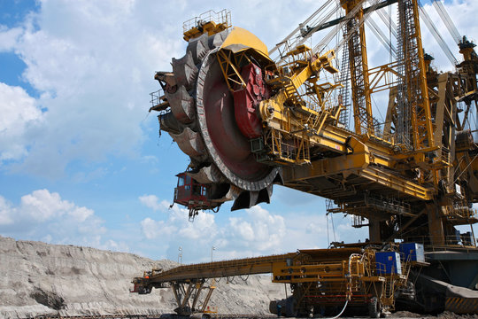 yellow big steel excavator in coal mine