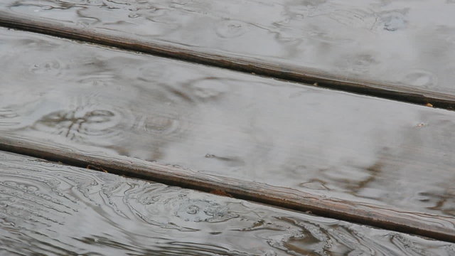 Raindrops falling onto wood