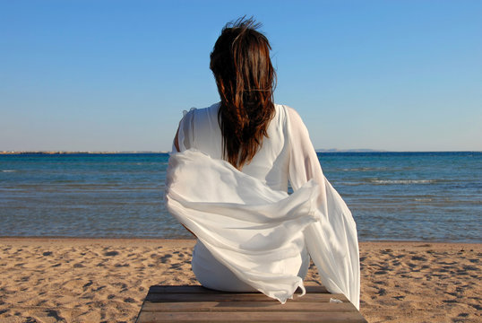 Woman Sitting On Beach