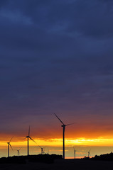 Fototapeta na wymiar Wind turbines during beautiful sunset