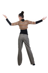 Beautiful young woman pointing at wall. Rear view.