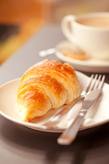 Cup of fresh hot  coffe with croissant