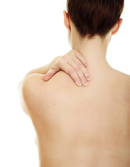 Woman massaging pain back isolated over a white background