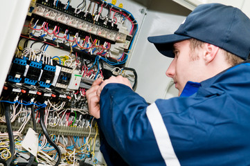 Electrician at voltage adjusting work