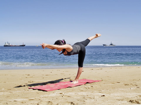 Bikram yoga tuladandasanal pose at beach