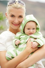 Mother with her adorable baby outdoors