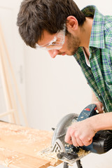 Home improvement - handyman cut wood with jigsaw
