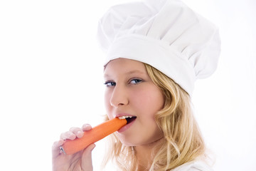 young cook, tasting a carrot