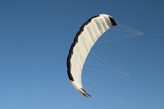 a parafoil paragliding on air with blue sky background