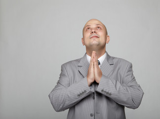 Bald businessman in a gray suit